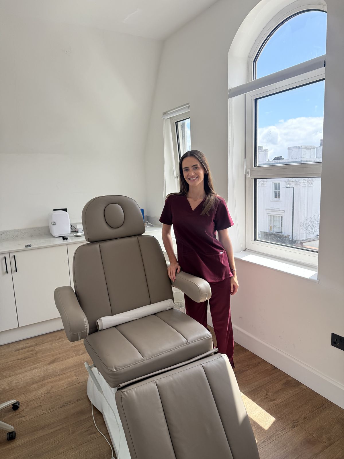 Lucy in her treatment room beside the clinic chair