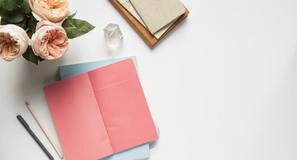 Notebook and flowers laid out for a consultation